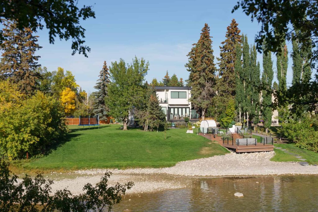 The backyard of a home in Elbow Park with a deck near the river.