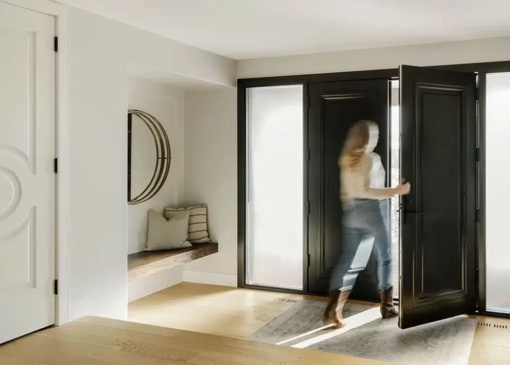 A home owner walking out the front door of their new custom home in Calgary.