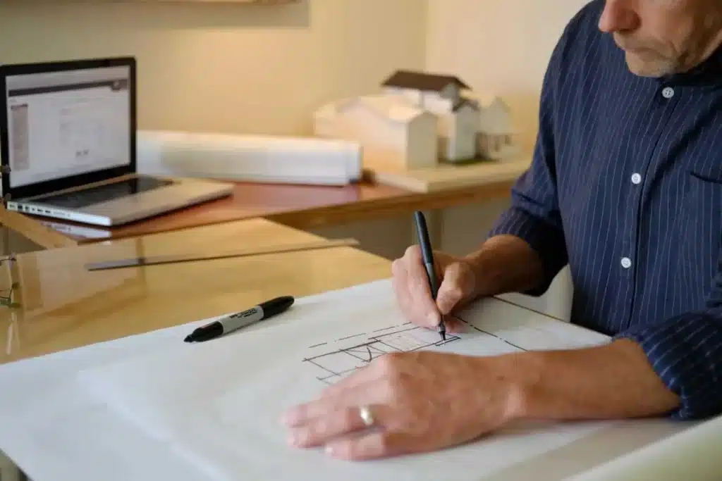 A Calgary home designer drawing renovation plans that include a secondary suite.