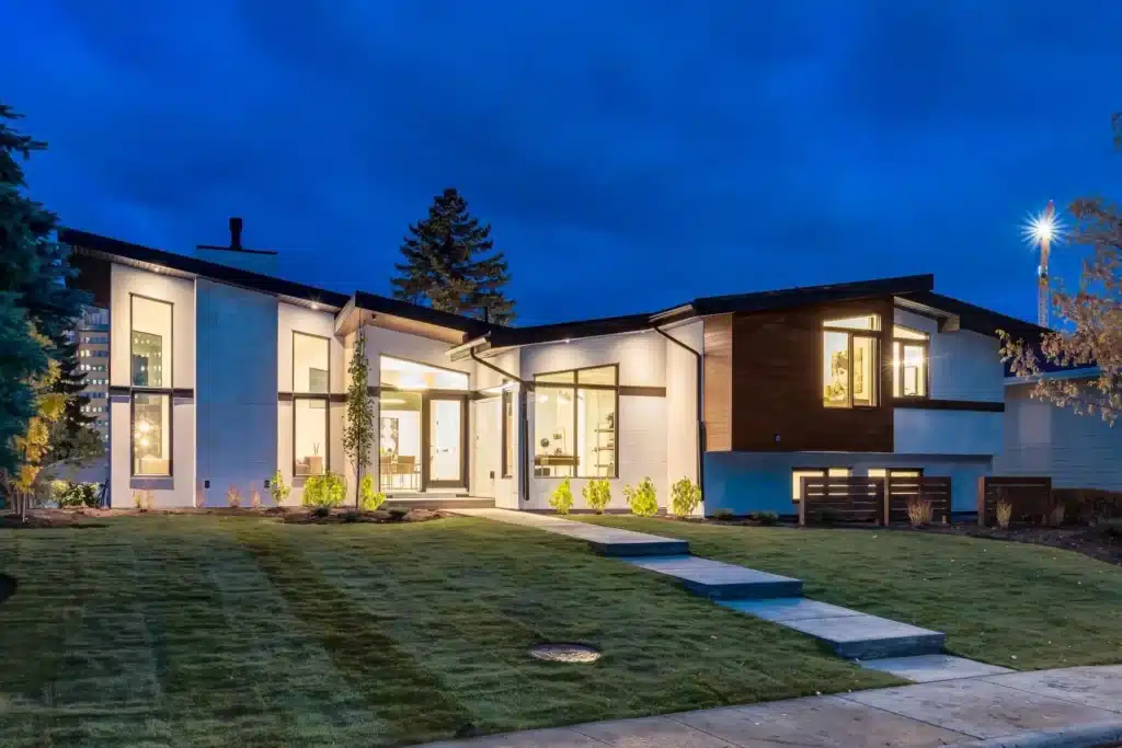 A new Calgary home lit up at night.
