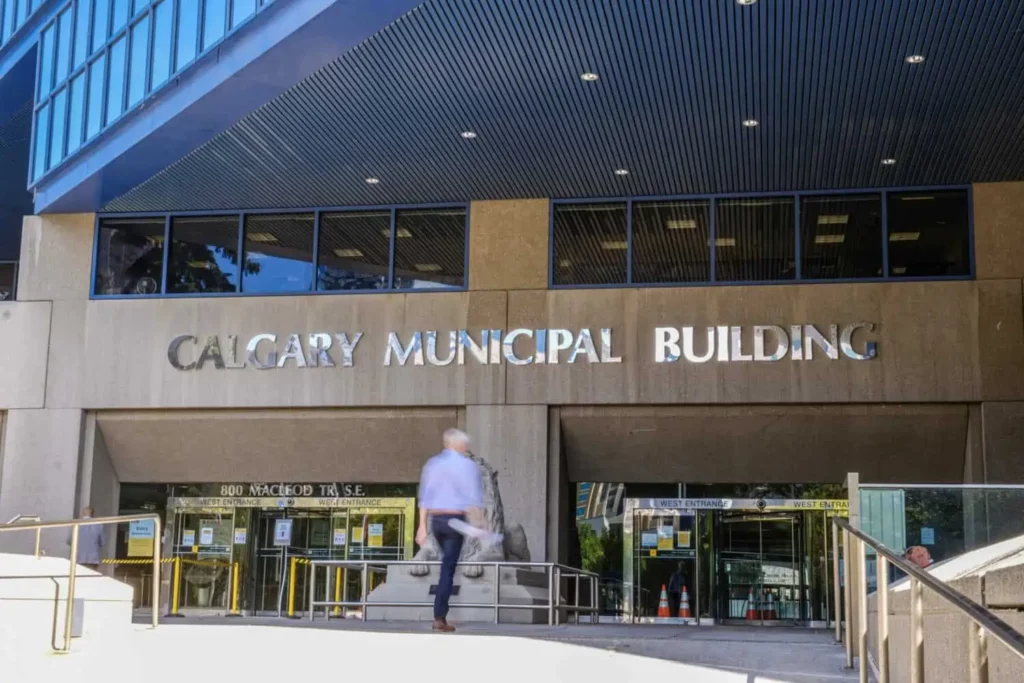 A residential designer walks into the Calgary municipal building to submit development permits.